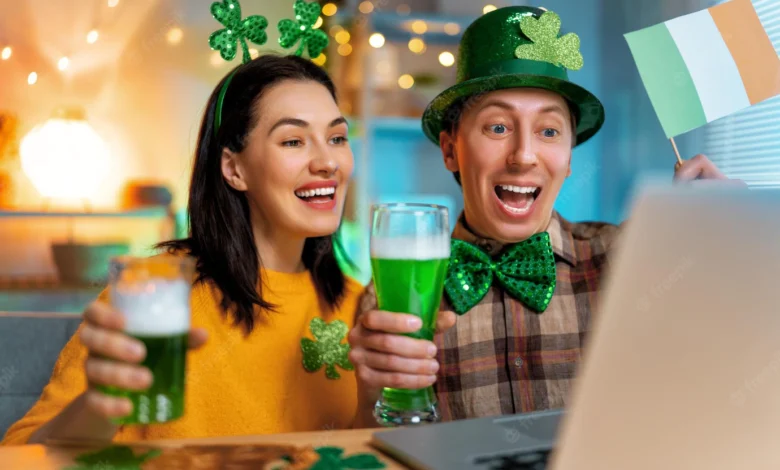 A couple shares a video call dress in St. Patrick’s Day costumes and holding an Irish flag