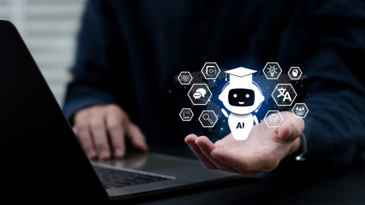 An AI chatbot icon appears above a hand beside a laptop