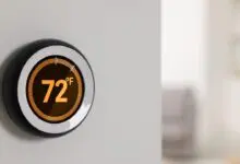 A smart thermostat on a wall shows 72°F