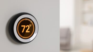 A smart thermostat on a wall shows 72°F