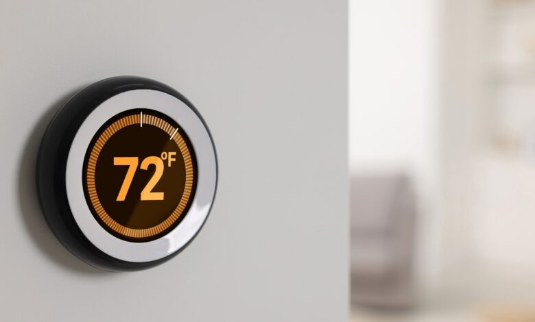 A smart thermostat on a wall shows 72°F