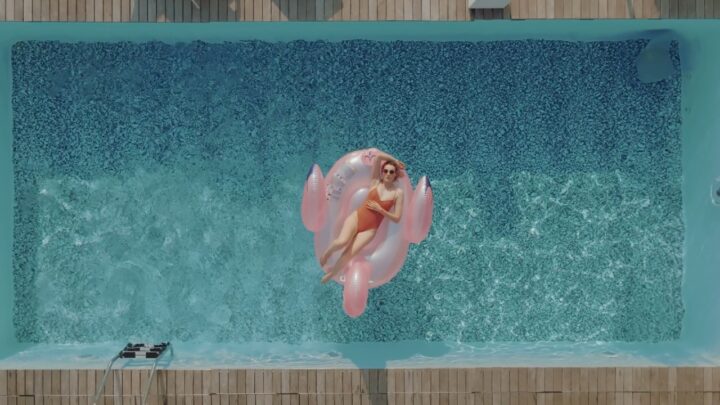 Person relaxing on a float in a small backyard pool